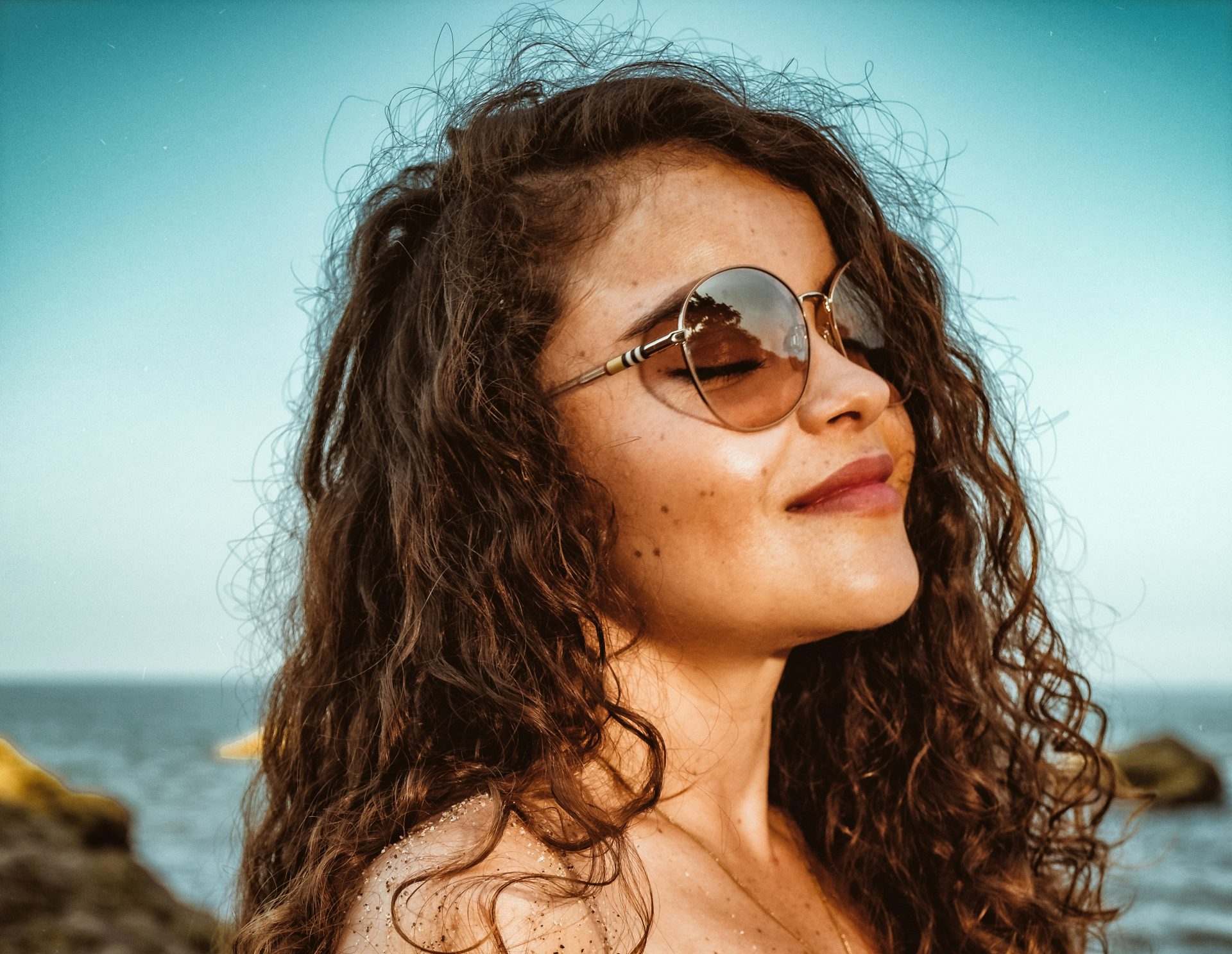 woman in black brassiere and black sunglasses